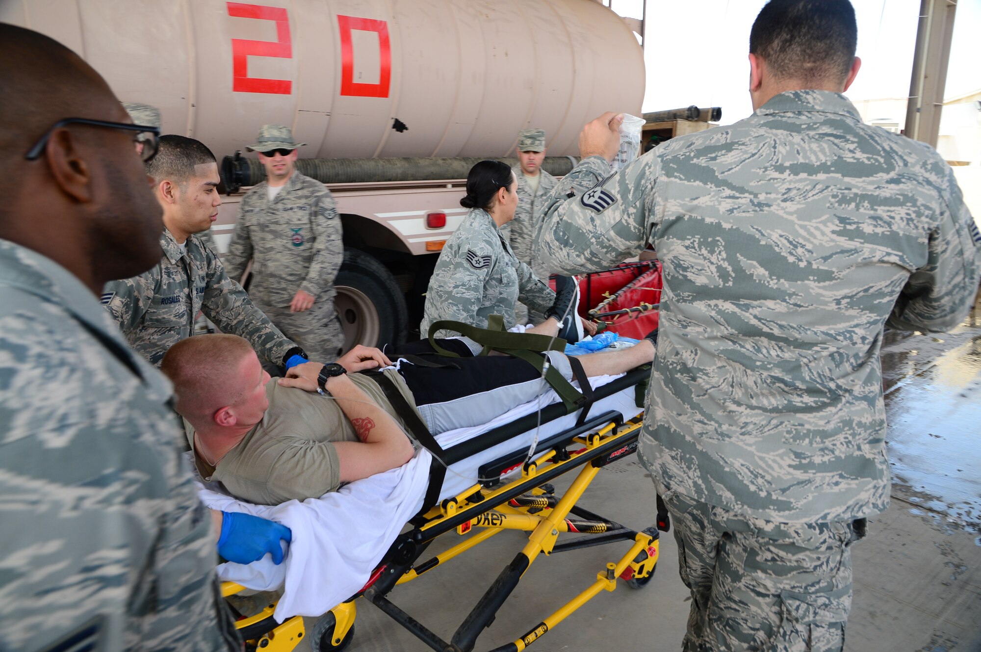 Airmen from the 386th Expeditionary Medical Group partnered with the 386th
Expeditionary Civil Engineering Squadron's Fire Department to participate in
a joint heat exhaustion exercise at an undisclosed location in Southwest
Asia. This type of training occurs twice a month and builds relationships
while ensuring protocol for accidents are standard across the wing. (U.S. Air Force photo by Senior Airman Desiree W. Moye)
 
