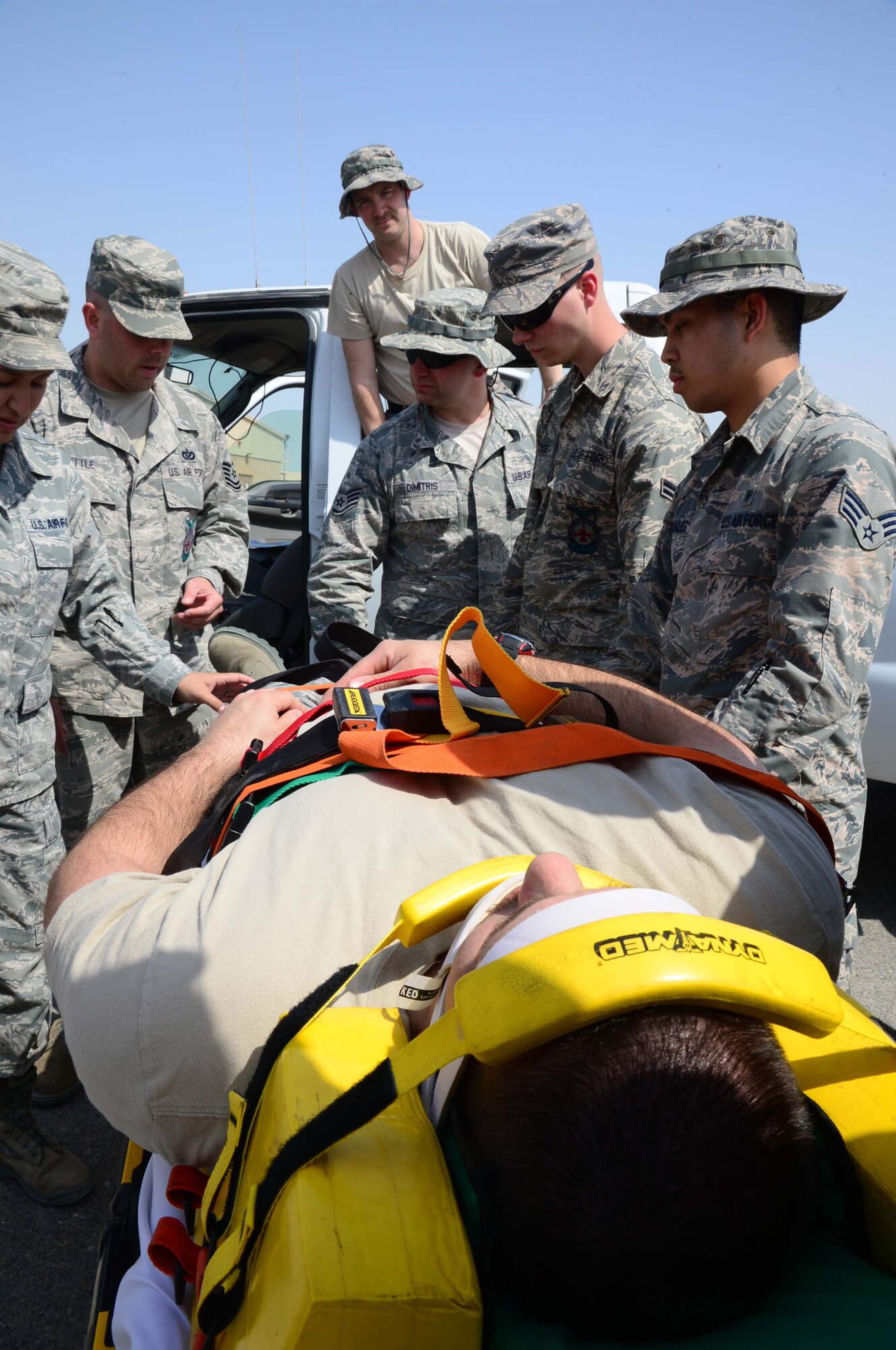 Airmen from the 386th Expeditionary Medical Group partnered with the 386th
Expeditionary Civil Engineering Squadron's Fire Department to participate in
a major vehicle accident victim extraction joint exercise at an undisclosed location in Southwest Asia. This type of training occurs twice a month and builds relationships while ensuring protocol for accidents are standard across the wing. (U.S. Air Force photo by Senior Airman Desiree W. Moye)

