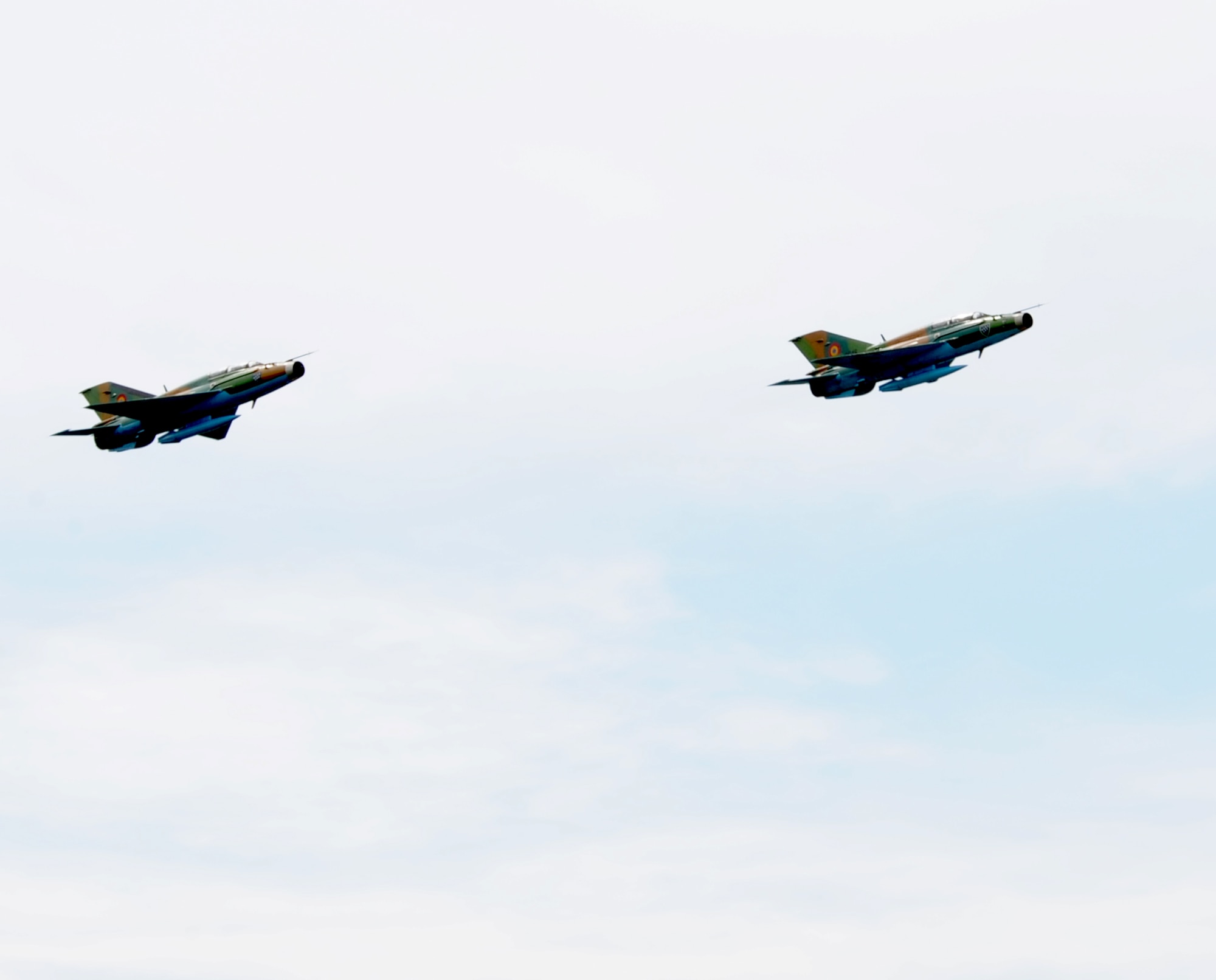 Two Romanian air force MiG-21 Lancers fly over Campia Turzii, Romania, April 17, 2014. U.S. Air Force F-16 Fighting Falcons and MiG-21s conducted air-to-air training during Exercise Dacian Viper 2014. (U.S. Air Force photo/Staff Sgt. R.J. Biermann)