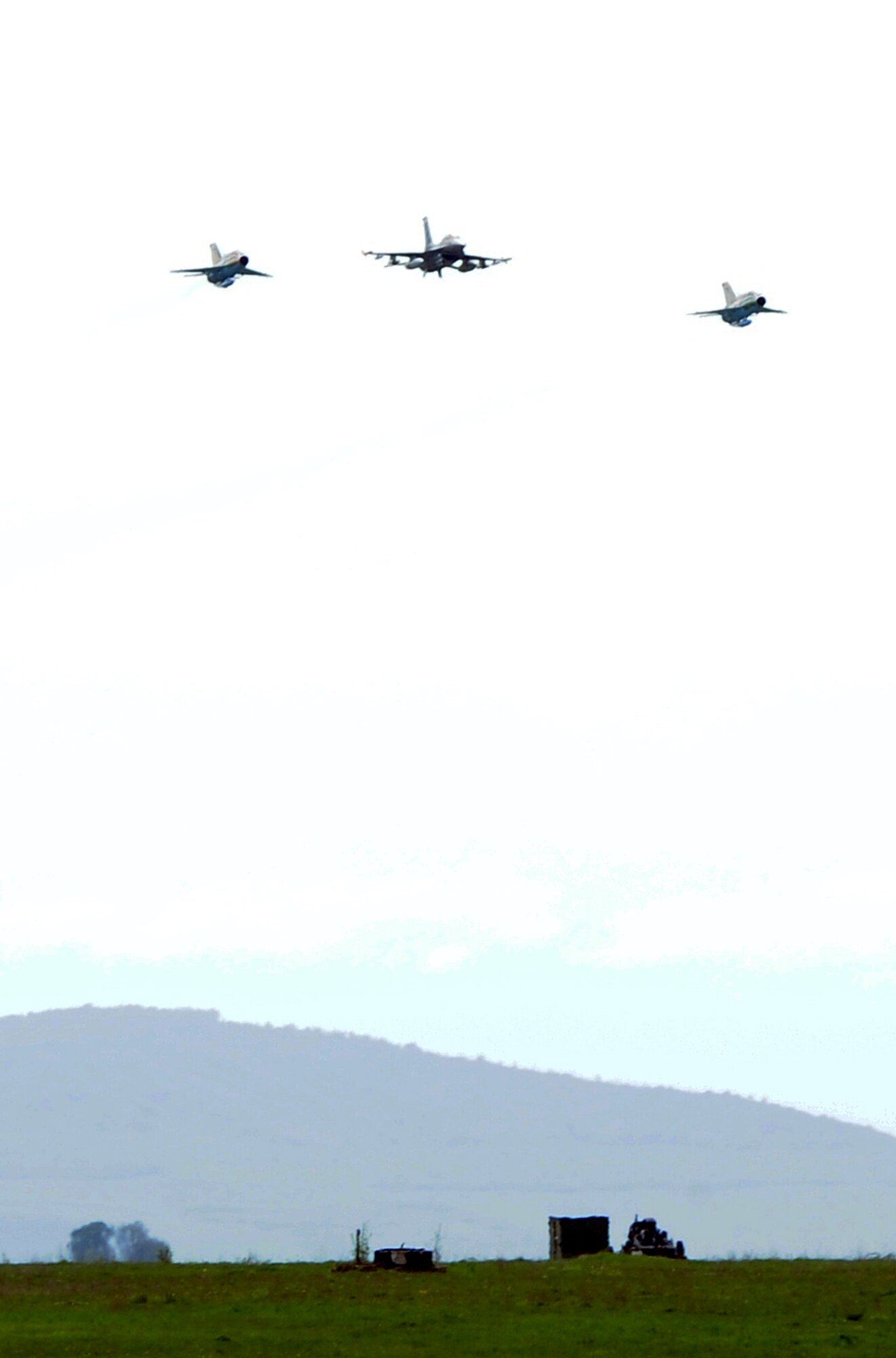 Two Romanian air force MiG-21 Lancers (left, right) and a U.S. Air Force F-16 Fighting Falcon fly over Campia Turzii, Romania, April 17, 2014, during Exercise Dacian Viper 2014. U.S. and Romanian air force jets flew several air-to-air missions together during the week-long exercise. (U.S. Air Force photo/Staff Sgt. R.J. Biermann)