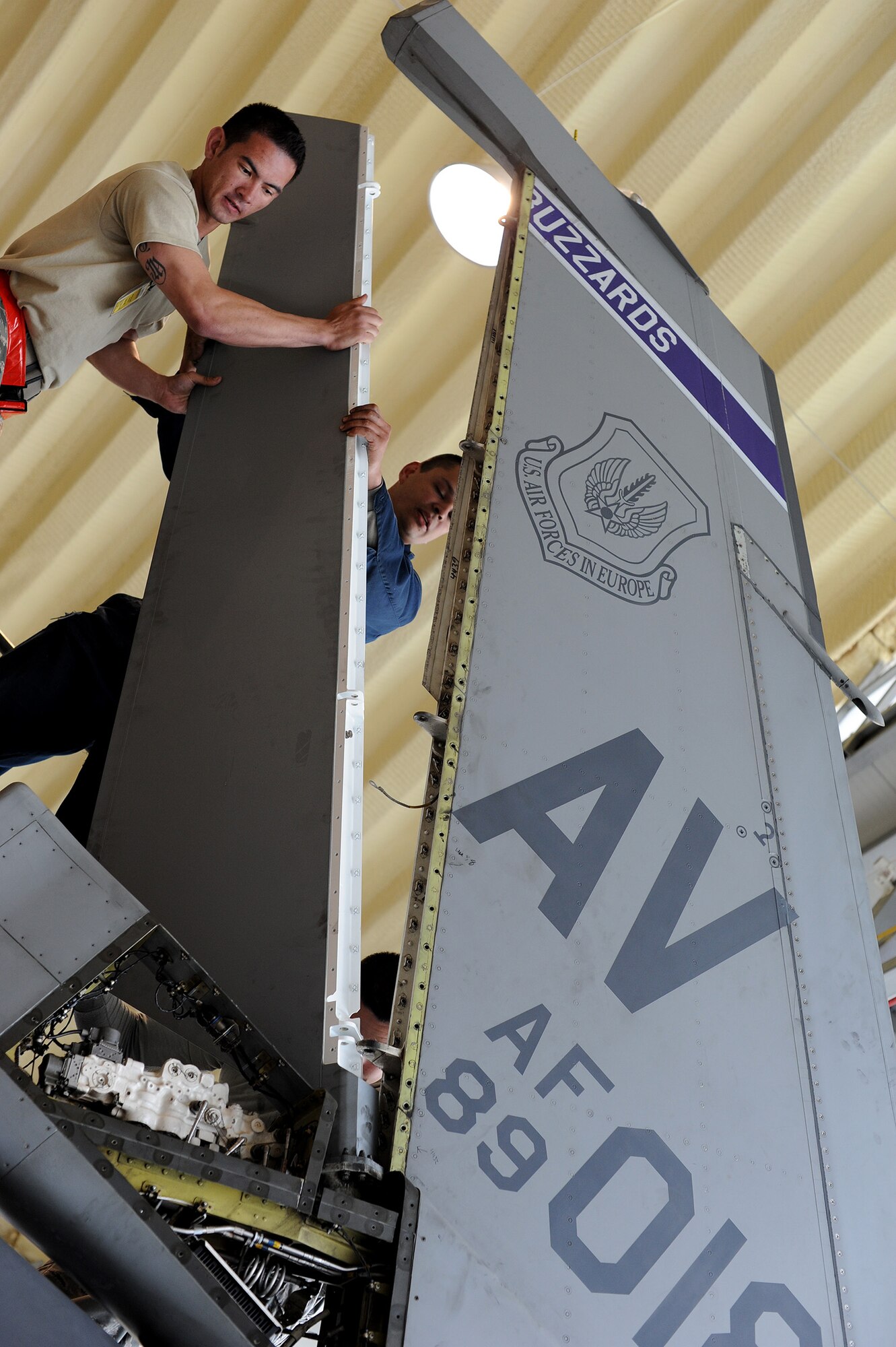 Airmen from the 31st Aircraft Maintenance Squadron install a new rudder on an F-16 Fighting Falcon at Campia Turzii, Romania, April 16, 2014. The original rudder was damaged, making the aircraft inoperable. (U.S. Air Force photo/Staff Sgt. R.J. Biermann)
