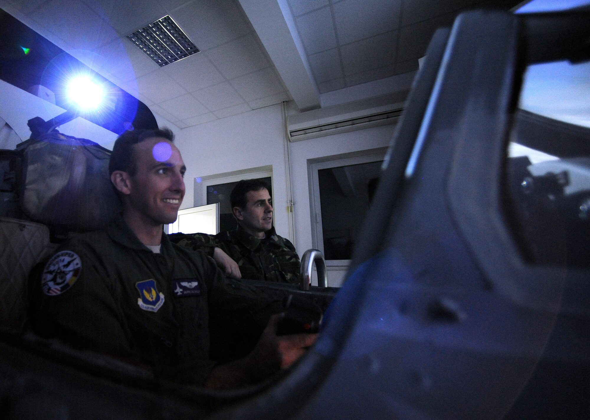 Capt. Nicolas DeWulf, 510th Fighter Squadron F-16 Fighting Falcon pilot, laughs while flying a MiG-21 Lancer simulator at Campia Turzii, Romania, April 14, 2014. Various American pilots, including DeWulf, had the opportunity to fly in the MiG-21 during Dacian Viper 2014, an interoperability exercise involving American and Romanian militaries. (U.S. Air Force photo/Staff Sgt. R.J. Biermann)