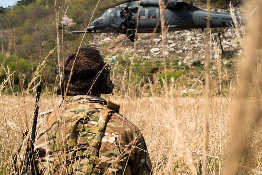 Tech. Sgt. Aaron Kuckovic, an 18th Operations Support Squadron Survial, Evasion, Resistance and Escape specialist, watches a departing HH-60 Pave Hawk helcopter during exercise Pacific Thunder April 14, 2014, in the Republic of Korea. Kuckovic and other SERE specialists were tested on their ability to successfully complete search and rescue missions during the week-long exercise. (U.S. Air Force photo by Staff Sgt. Jake Barreiro)