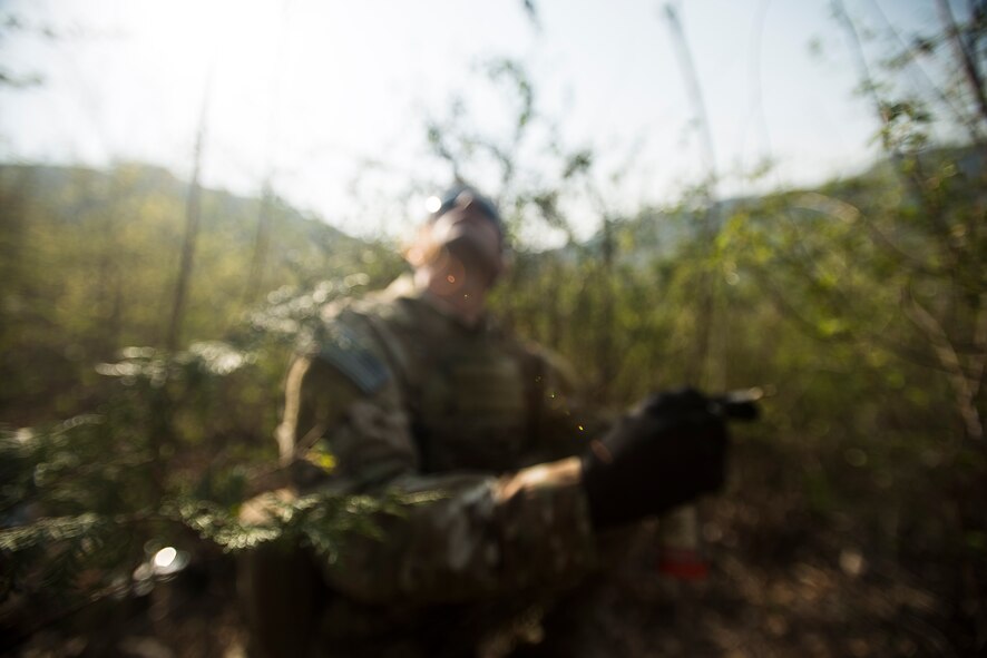 Tech. Sgt. Aaron Kuckovic, an 18th Operation Support Squadron Survial, Evasion, Resistance and Escape specialist, scans the sky for an incoming HH-60 Pave Hawk helicopter during exercise Pacific Thunder April 14, 2014, in the Republic of Korea. Pacific Thunder is a week-long exercise featuring joint training between United States and RoK forces. (U.S. Air Force photo by Staff Sgt. Jake Barreiro)