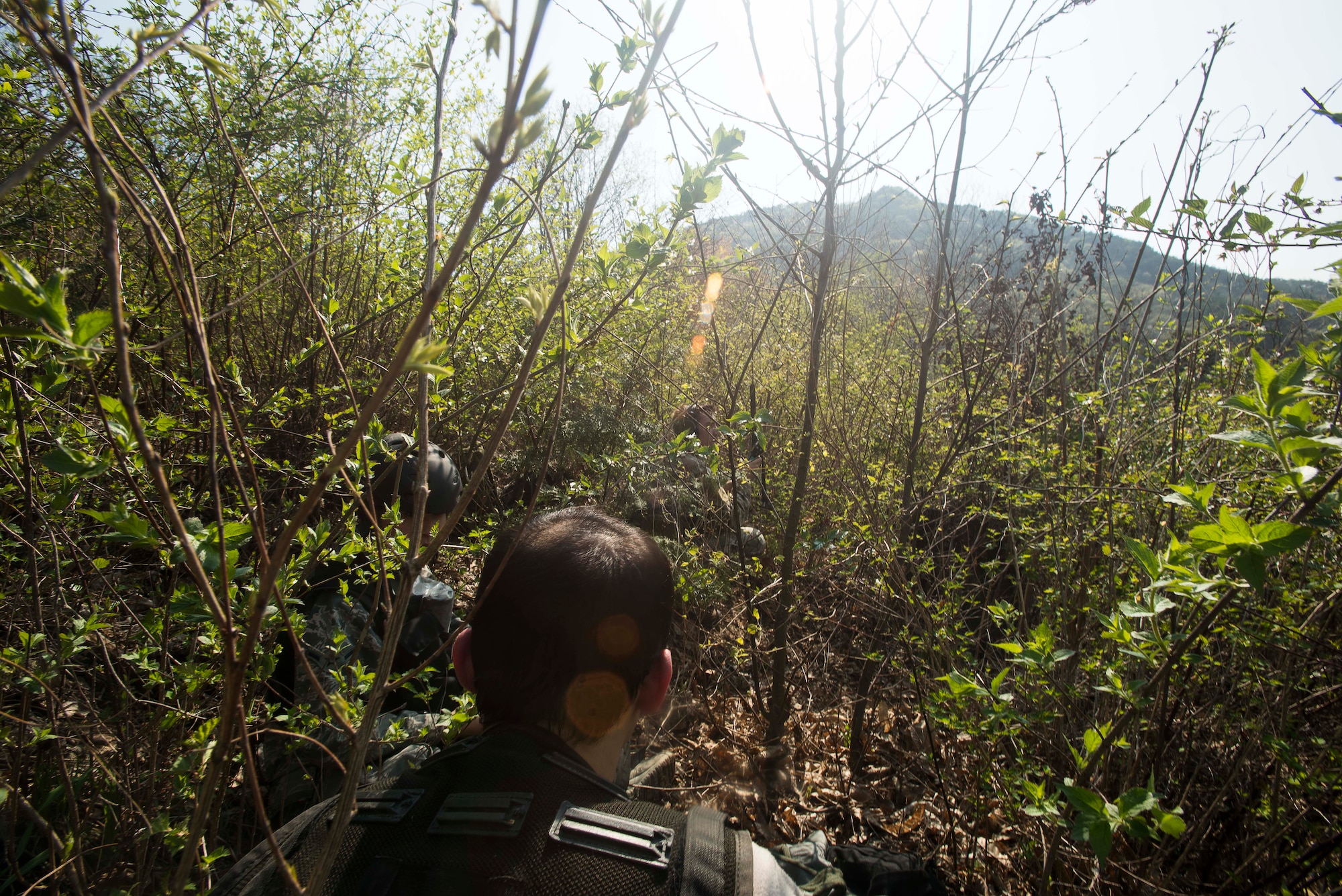 Tech. Sgt. Aaron Kuckovic, an 18th Operations Support Squadron Survial, Evasion, Resistance and Escape specialist, waits at a rendezvous point with simulated victims during the exercise Pacific Thunder April 14, 2014, in the Republic of Korea. Pacific Thunder is an annual exercise hosted by Osan Air Base, focusing on combat readiness via search and rescue training. (U.S. Air Force photo by Staff Sgt. Jake Barreiro)