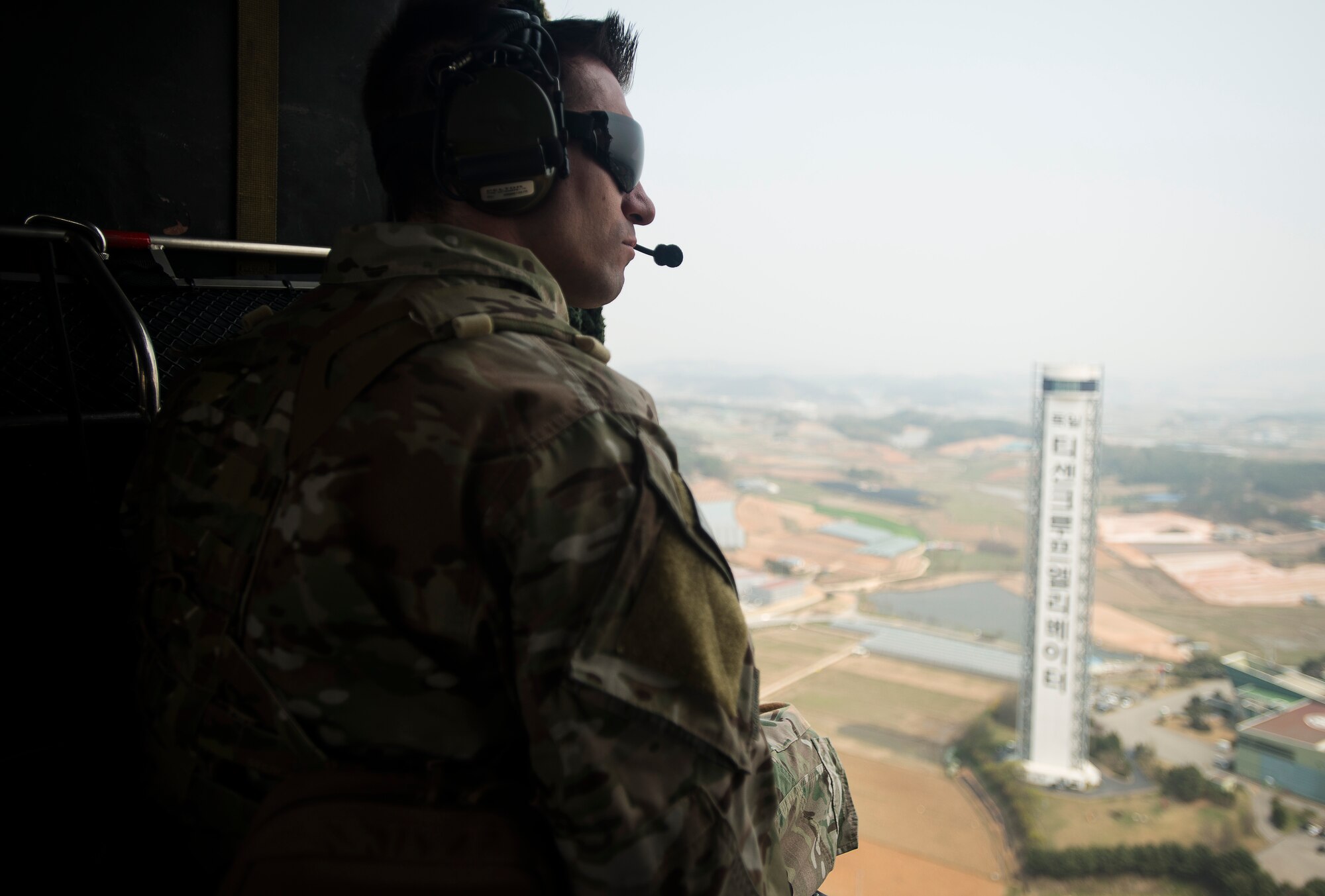 Tech. Sgt. Aaron Kuckovic, an 18th Operations Support Squadron Survial, Evasion, Resistance and Escape specialist, sits by the door of a HH-60 Pave Hawk Helicopter during exercise Pacific Thunder April 14, 2014, in the Republic of Korea. Pacific Thunder is designed to test the combat and contingency readiness of United States and RoK forces. (U.S. Air Force photo by Staff Sgt. Jake Barreiro)