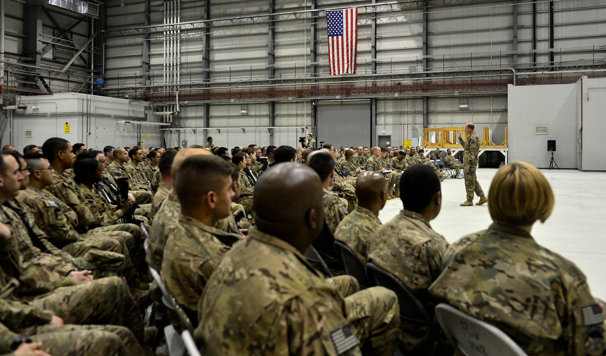 Chief Master Sgt. of the Air Force James Cody speaks to about 500 Airmen during a visit to Bagram Air Field, Afghanistan, April 13, 2014. CMSAF Cody visited Bagram Air Field to encourage, inform and congratulate Airmen for hard work throughout Operation Enduring Freedom. His tour of Bagram concluded with a 60-minute question and answer all-call. (U.S. Air Force photo/Staff Sgt. Vernon Young Jr.)