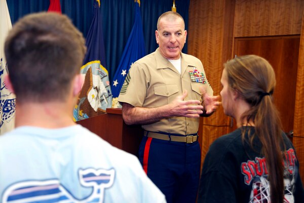 Marine Corps Sgt. Maj. Bryan B. Battaglia, senior enlisted advisor to the chairman of the Joint Chiefs of Staff, talks to applicants about military commitment and service to their country before administering the ceremonial oath of enlistment at the Military Entrance Processing Station in Jacksonville, Fla., April 16, 2014.