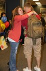 Caitlin A. Wilde, wife of Sgt. Tyler R. Wilde, a flight line mechanic with Marine Heavy Helicopter Squadron (HMH) 464, reunites with her husband in the lobby of the Albert J. Ellis Airport in Jacksonville, N.C., April 20, 2014, after six months of separation while he was deployed to Okinawa, Japan, with HMH-464. Nine Marines, including Wilde, were part of the advance party’s return from the six-month deployment. (U.S. Marine Corps photo by Sgt. Alicia R. Leaders/Released)