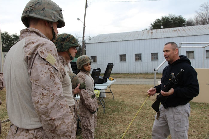 Mark Richter (right), Marine Corps Systems Command’s Marine Expeditionary Rifle Squad team lead, explains the Marine Corps Load Effects Assessment Program, or MCLEAP, course to Marines from The Basic School Dec. 20, 2013, on Marine Corps Base Quantico, Va. The Marines were performing new equipment testing on the fitLight Trainer timing system, an upgrade MERS made to MCLEAP to obtain more concise data for improving current and future gear for infantry Marines. 