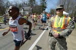 Spc. Brandon Smith, 169th Military Police Company, Rhode Island Army National Guard, pulls security during the starting line of the 2014 Boston Marathon, April 21, 2014. Approximately 600 Massachusetts National Guard members were deployed along the route to assist local authorities in ensuring that the 2014 Boston Marathon is as safe as realistically possible. Due to the record number of runners this year, Guardsmen from numerous states are augmenting the Massachusetts National Guard's own specialized units.