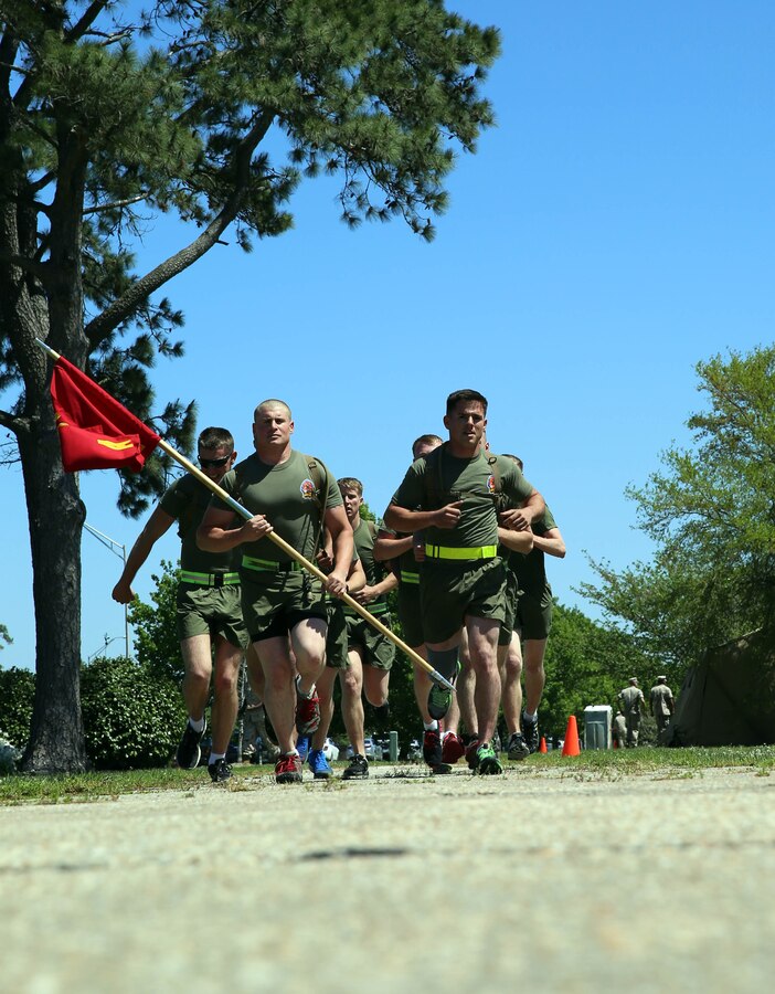 Marines with Alpha Company, 2nd Light Armored Reconnaissance Battalion run with their guidon for the R.A.C.E for Suicide Awareness held at Marine Corps Base Camp Lejeune, NC, April 16, 2014. The relay lasted 24 hours, and was focused on building unit cohesion, and increasing awareness of suicide prevention in order to maintain mission readiness, enhance unit camaraderie and cohesion, and heighten force preservation.