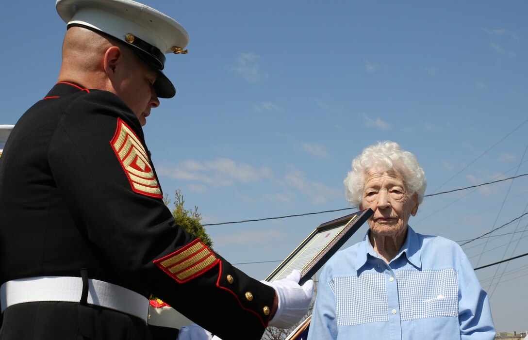 Remington, Ind. - 1st Sgt. Gregory Zieba, the first sergeant of Detachment 1, Communications  Company, Combat Logistics Regiment 45, 4th Marine Logistics Group, of Peru, Ind., reads a letter from the Commandant of the Marine Corps to Mary Cochrane. the Marines delivered a birthday cake to Cochrane for her 100th birthday, April 18, 2014. Cochrane served as a motor transportation operator during World War II. She celebrated her birthday Friday with family at her home in Remington, Ind.