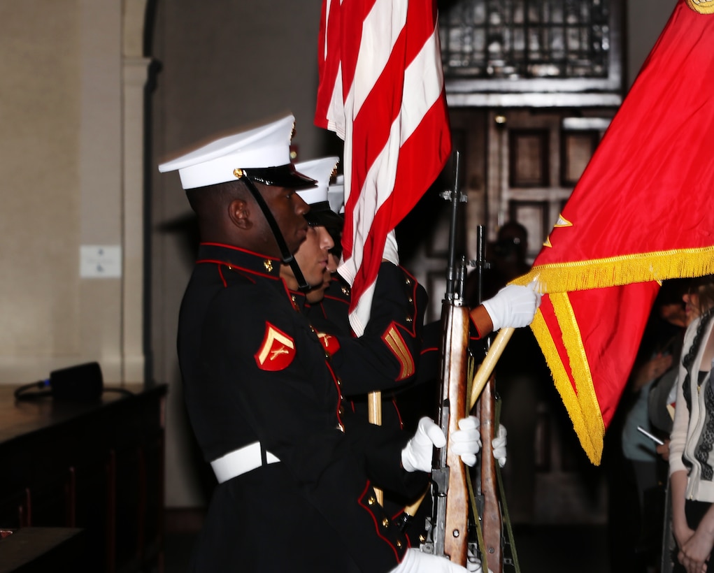 Marines with the Combat Center Color guard hold the national and Marine Corps colors in place during the playing of the national anthem at the University of Redlands April 12, 2014. The symphony was held in honor of service members and the upcoming 70th anniversary of the landing at Normandy, also known as D-Day.