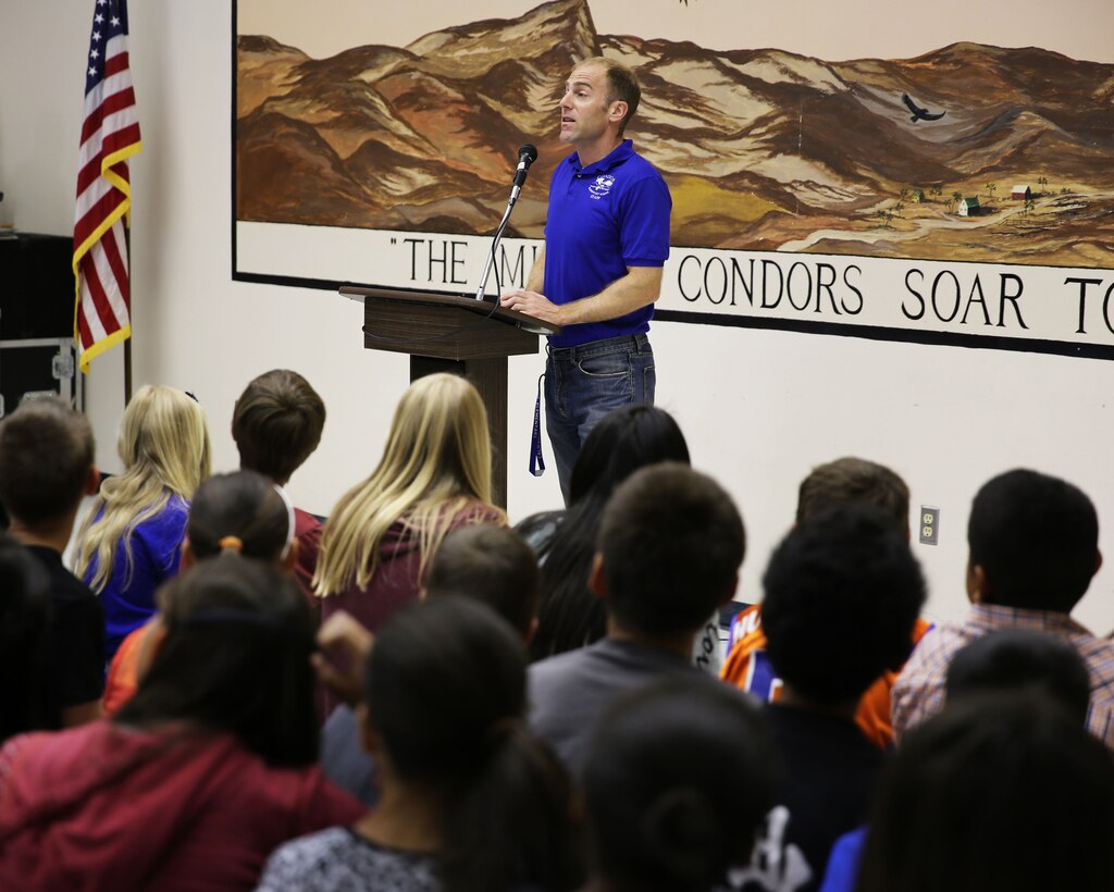 Paul Gattuso, principal, Condor Elementary School, addresses students and their parents during a performance and achievement ceremony at the school, April 11, 2014. The awards, which happen three times a year, are a good way to help teachers motivate their students to achieve higher academic and behavioral goals, according to Gattuso. (Official Marine Corps Photo By Lance Cpl. Kasey Peacock/Released)
