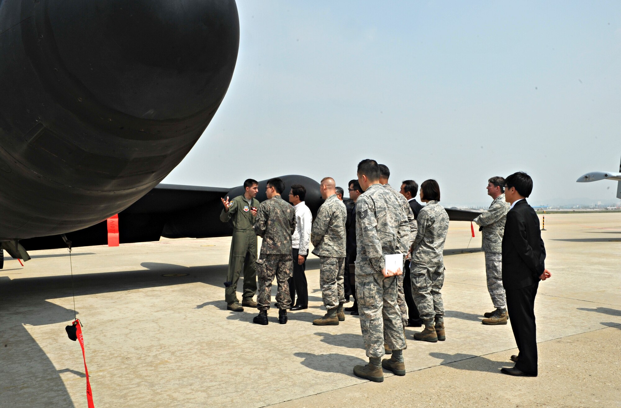 Capt. James (last name withheld due to operational security constraints), 5th Reconnaissance Squadron U-2 Dragon Lady pilot, briefs Moon-soo Kim,  Gyeonggi-do province governor, on the airframe during a visit to Osan Air Base, Republic of Korea, April 21, 2014. James explained the term “dragon lady,” which likens the experience of landing the plane to dancing with a lady at times and to wrestling with a dragon at others. (U.S. Air Force photo/Airman 1st Class Ashley J. Thum)