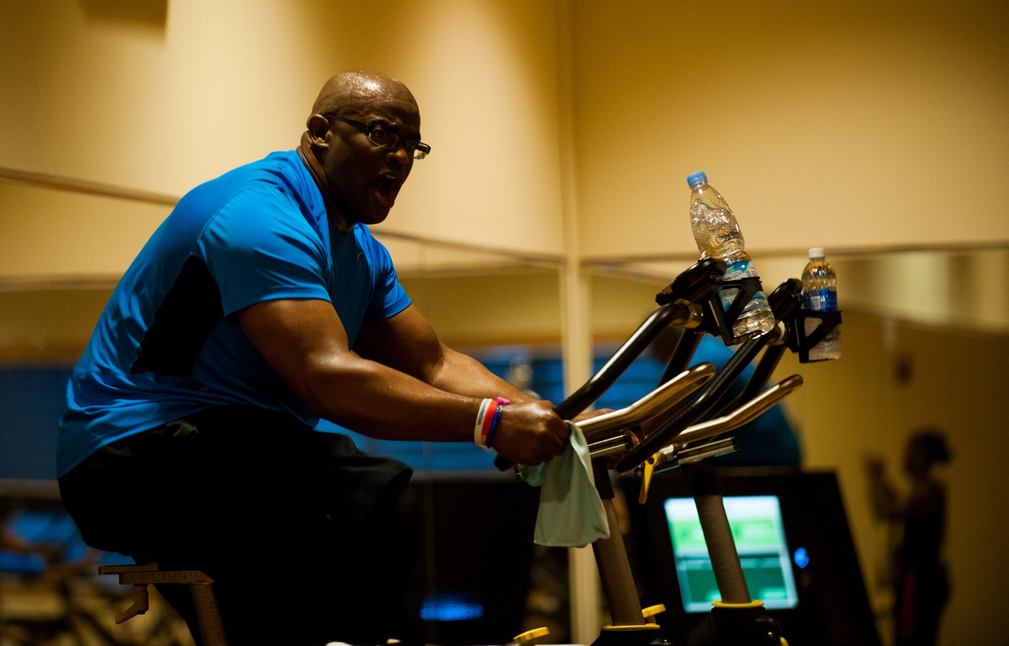 Master Sgt. Dante Brooks, 8th Operations Support Squadron host aviation resource management superintendent, leads a spin class at Kunsan Air Base, Republic of Korea, April 16, 2014. Brooks keeps the Wolf Pack fit to fight by leading spin class four times a week. (U.S. Air Force photo by Staff Sgt. Clayton Lenhardt/Released)