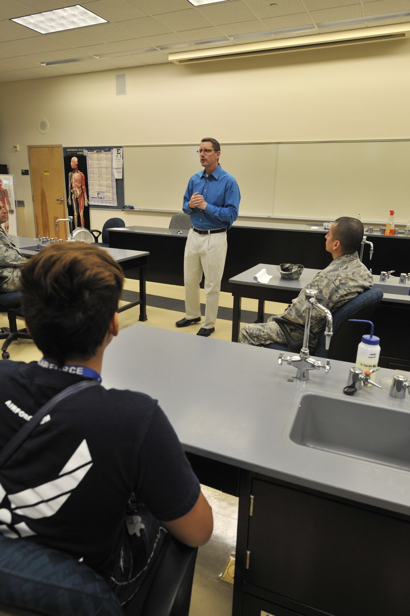 Mr. Barry Miller speaks to a classroom of Delayed Entry Program members at the education center on Fairchild Air Force Base, Wash., April 18, 2014. Miller spent time informing the group of the educational benefits they would recieve as active-duty members. Miller is a 92nd Force Support Squadron education advisor. (U.S. Air Force photo by Senior Airman Mary O'Dell/Released)