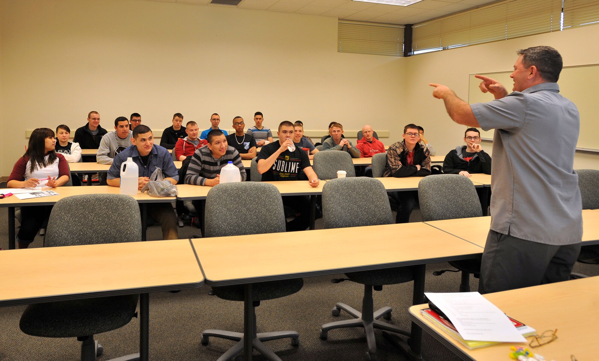 Maj. Sean Goode briefs Airmen from the squadron before an Air Force Smart Operations for the 21st century event where the Airmen learned to apply eight-step process to promote awareness of underage drinking, April 15, 2014, at Fairchild Air Force Base, Wash. The AFSO21 principles and tools enable Airmen to change the day-to-day operating style to integrate continuous improvement into the full spectrum of Air Force operations, and can be applied to any aspect of the mission. Goode is the 92nd Maintenance Squadron commander. (U.S. Air Force photo by Staff Sgt. Veronica Montes/Released)