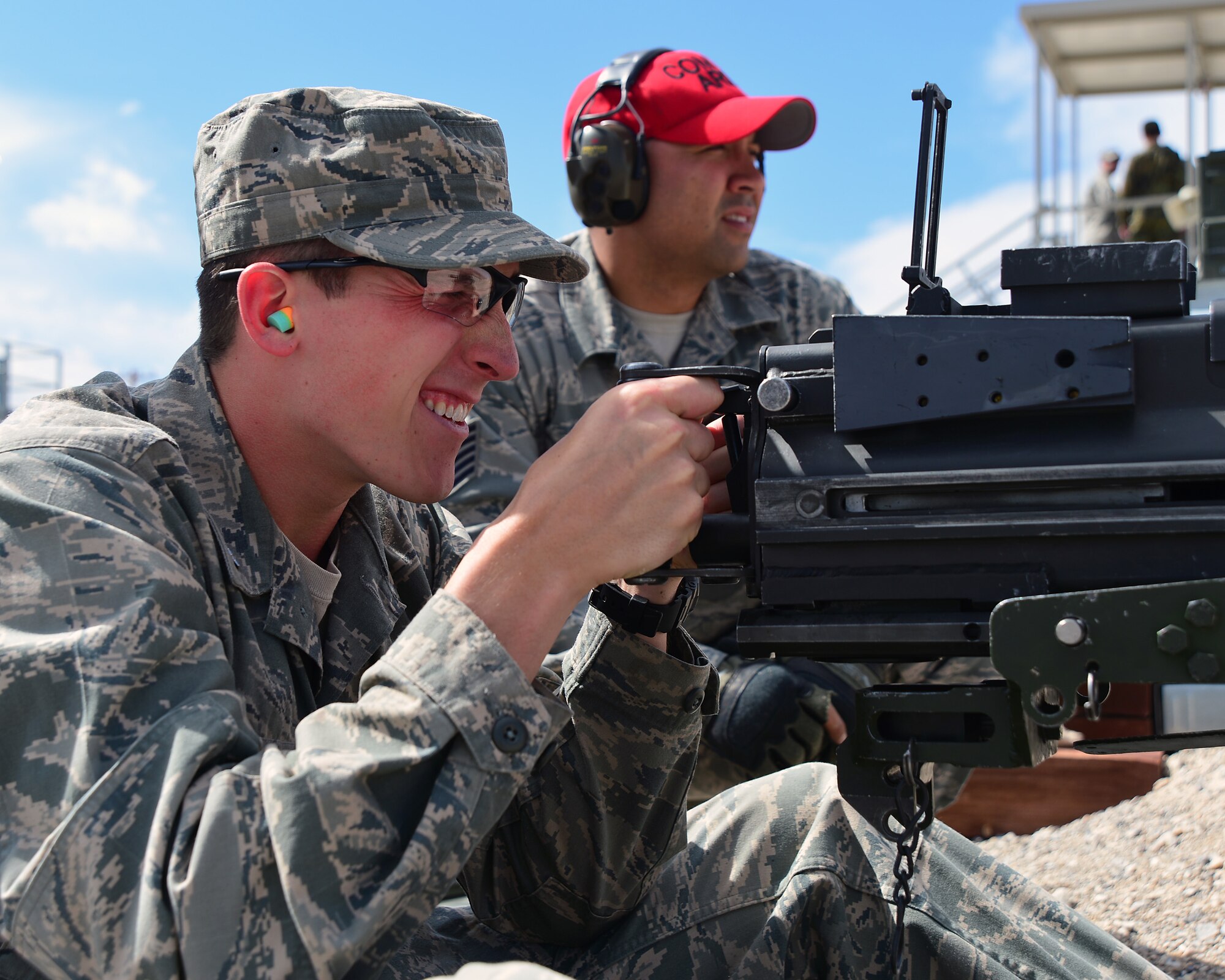 Cadet 4th Class Seth Wynn, U.S. Air Force Academy student, fires a MK-19 40mm machine gun after receiving safety instructions from Tech. Sgt. Chris Carlisle, 99 Ground Combat Training Squadron noncommissioned officer of combat arms, April 11, 2014. During the visit to Creech Air Force Base, Nev., the cadets learned about the missions conducted by the 432nd Wing and 799th Air Base Group.  (U.S. Air Force Photo by Tech. Sgt. S.E./Released)