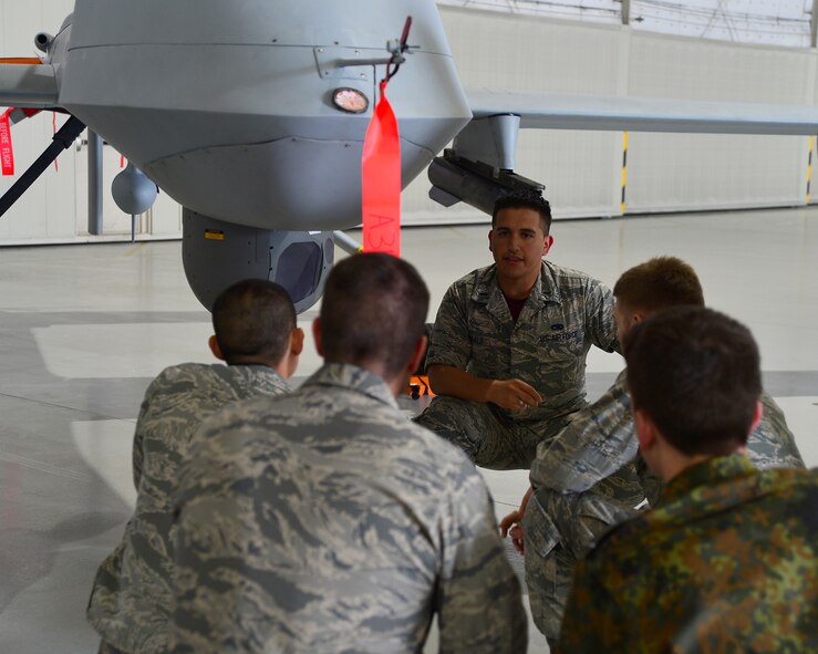1st Lt. Bryan Beals, 432nd Aircraft Maintenance Squadron Reaper Aircraft Maintenance Unit assistant officer in charge, explains the capabilities of the MQ-1 Predator remotely piloted aircraft to U.S. Air Force Academy cadets April 11, 2014. The cadets visited Creech Air Force Base, Nev. to learn about RPAs and the 432nd Wing mission. (U.S. Air Force Photo by Tech. Sgt. S.E./Released)