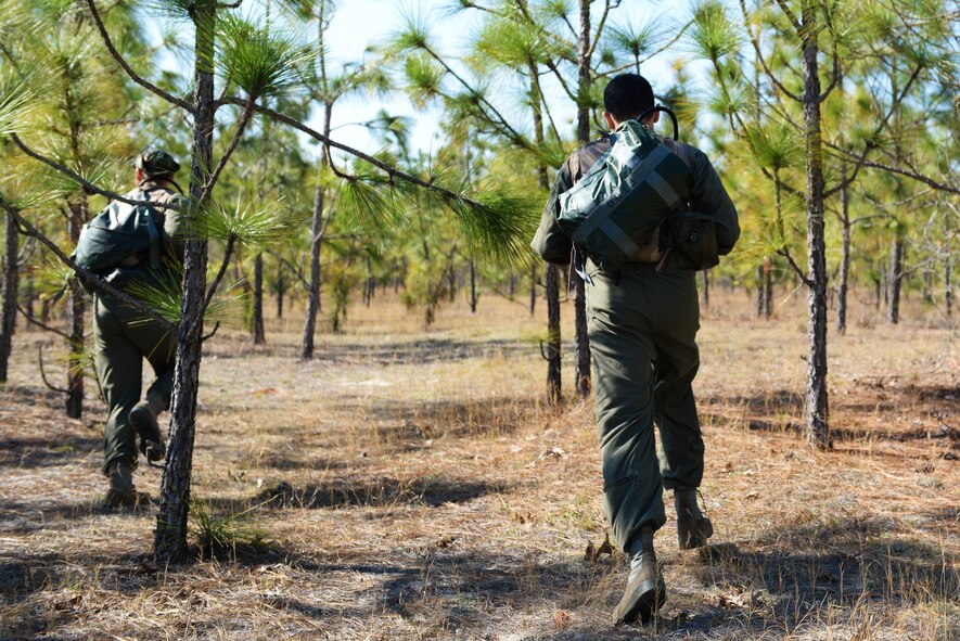 [Left to right] U.S. Air Force Capt. Jeremy Smallwood, 77th Fighter Squadron electronic combat pilot, and Capt. Stephen Jude, 77th FS chief of training, run while participating in survival, evasion, resistance, escape training at Poinsett Range near Wedgefield, S.C., April 16, 2014. During the training, two, two-man teams ran from their simulated downed aircraft to avoid hostile forces and find adequate cover. (U.S. Air Force photo by Airman 1st Class Diana M. Cossaboom/Released)