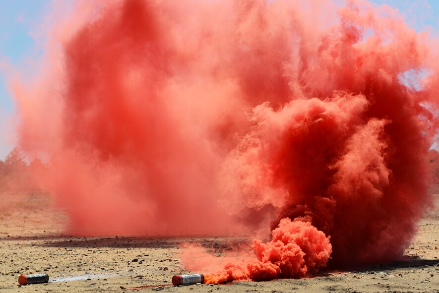 Red smoke fills the air from a MK13 red flare during survival, evasion, resistance, escape training at Poinsett Range near Wedgefield, S.C., April 16, 2014. Pilots have to participate in a SERE refresher course every three years to stay up to date with their flying requirements. (U.S. Air Force photo by Airman 1st Class Diana M. Cossaboom/Released)