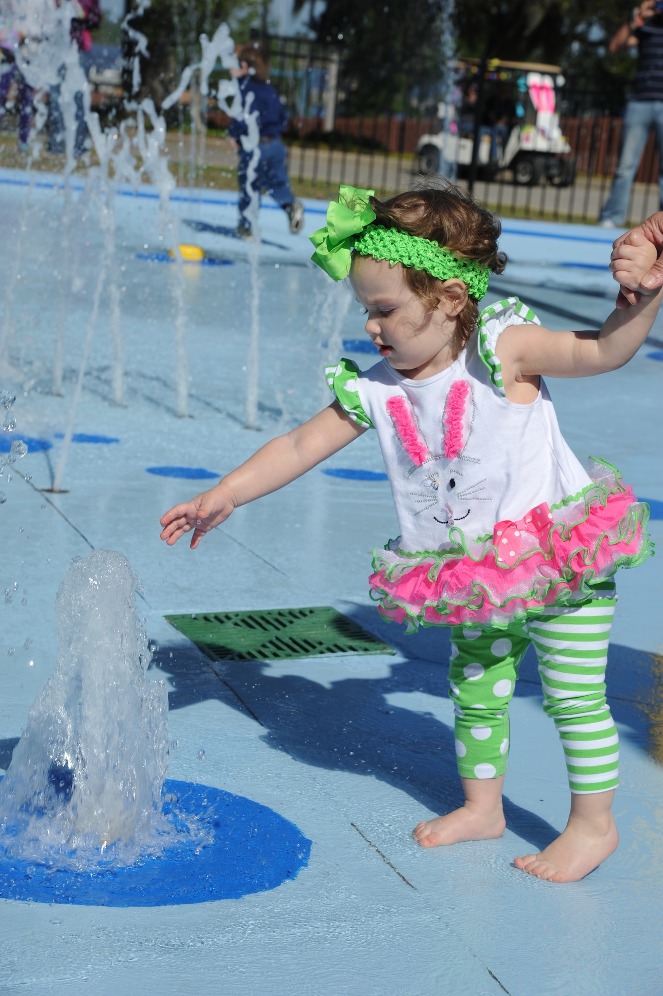 The great-granddaughter of retired Senior Master Sgt. Bob Ochoa plays with the water during the Keesler Outdoor Recreation’s Splash Pad grand opening at the marina April 19, 2014, at Keesler Air Force Base, Miss.  The splash pad was funded with a portion of the 2013 Commander-in-Chief Installation Excellence award funds.  (U.S. Air Force photo by Kemberly Groue)