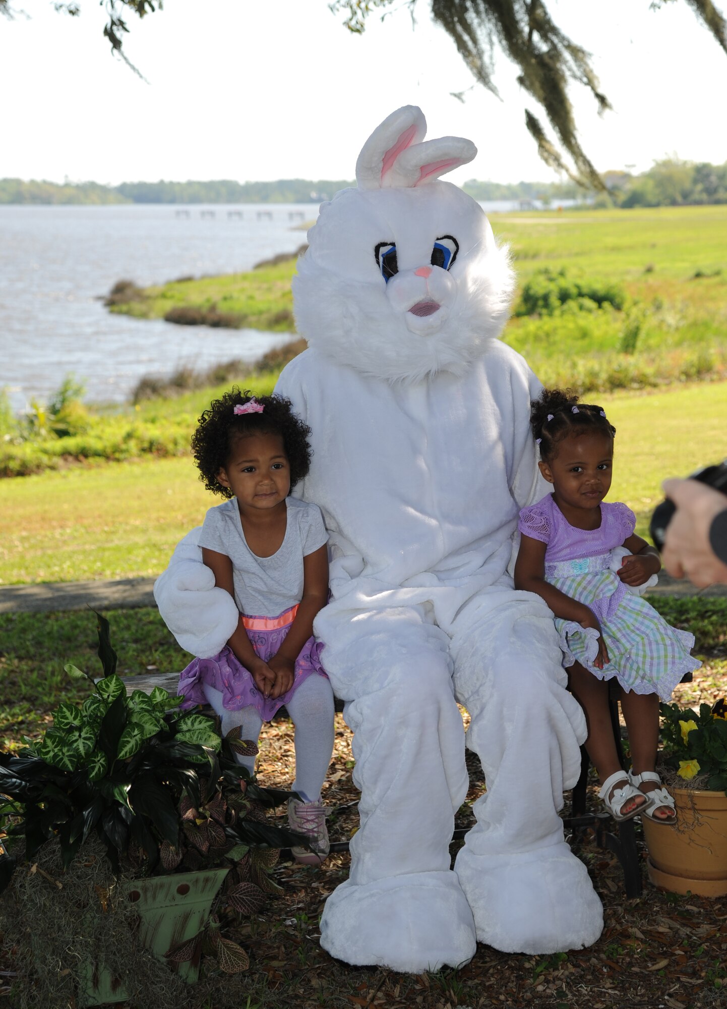 The daughters of Staff Sgts. Hana Webb, 81st Medical Support Squadron, and Tigist Belema, 81st Medical Operations Squadron, take a photo with the Easter Bunny at the Keesler Marina April 19, 2014, at Keesler Air Force Base, Miss.  A parade through the marina, an Easter egg hunt and the grand opening of the outdoor recreation’s splash pad took place prior to a photo session with the Easter Bunny.  (U.S. Air Force photo by Kemberly Groue)