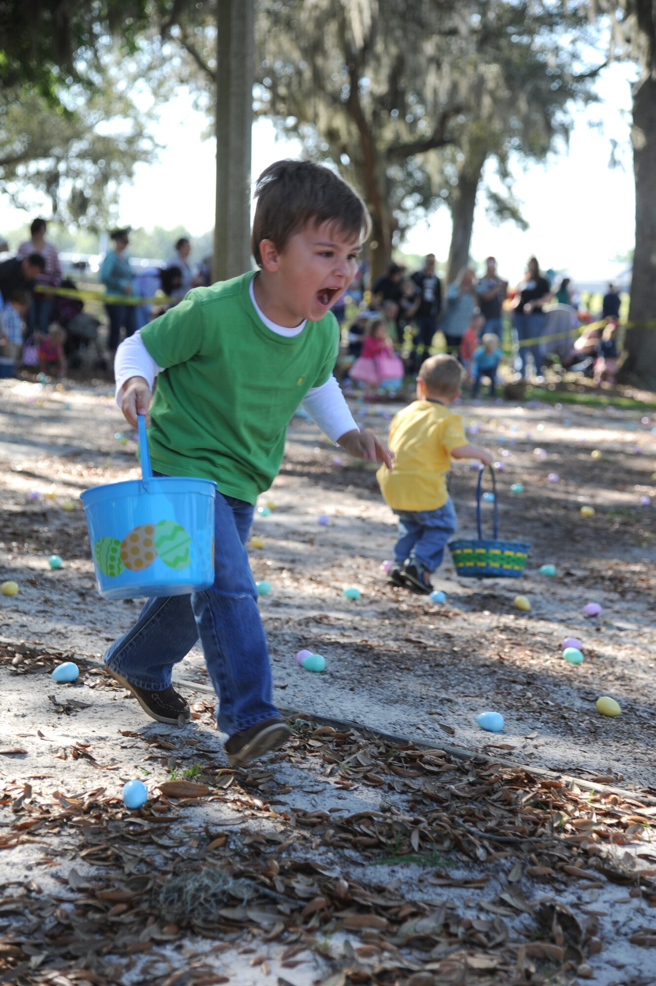 The grandson of retired Master Sgt. Robert Ellis runs in excitement toward plastic eggs during an Easter egg hunt April 19, 2014, at the marina, Keesler Air Force Base, Miss.  A parade through the marina preceded the hunt then the grand opening of the outdoor recreation’s splash pad immediately completed the festivities.  (U.S. Air Force photo by Kemberly Groue)