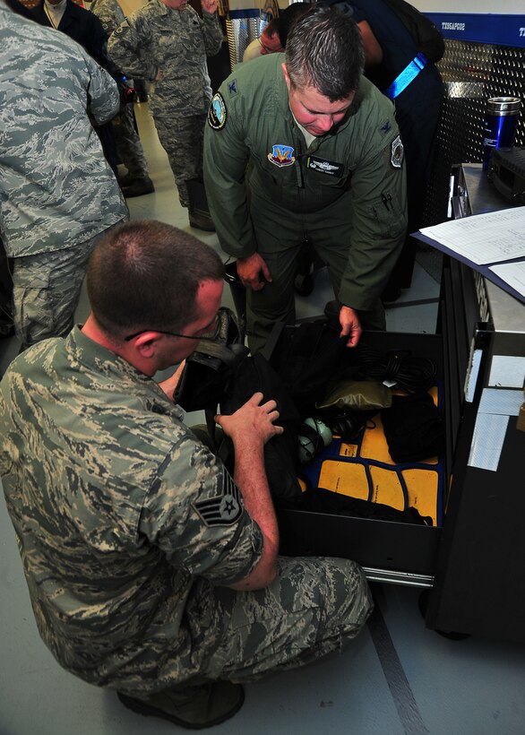 Staff Sgt. Simon S. Zemanek, 95th Aircraft Maintenance Unit tactical aircraft maintenance crew chief, shows Col. David E. Graff, 325th Fighter Wing commander, the different tools he uses to work on F-22 Raptors April 18 at the 95th AMU office. Zemanek was shadowed by the commander as part of the Airman Shadow Program. (U.S. Air Force photo by Airman 1st Class Sergio A. Gamboa)