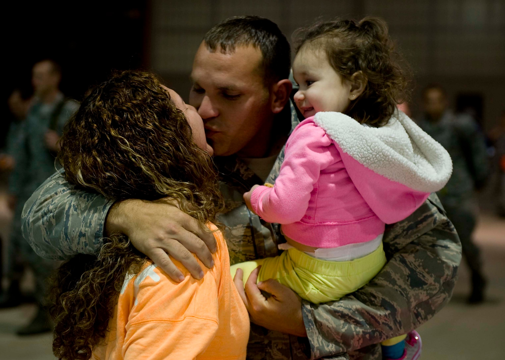 U.S. Air Force Staff Sgt. Daniel Caban, 94th Aircraft Maintenance Unit crew chief, reunites with his wife Jennifer Caban and daughter Serenity Caban at Langley Air Force Base, Va., April 19, 2014. The 94th Fighter Squadron was deployed for nearly four-months to Kadena Air Base, Japan, to demonstrate the continued U.S. commitment to maintain peace throughout the Western Pacific.  (U.S. Air Force photo by Staff Sgt. John D. Strong II/Released)