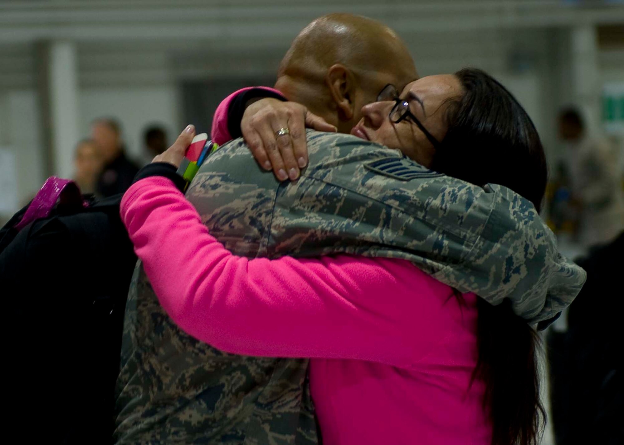 U.S. Air Force Tech. Sgt. Abraham Lailson, 1st Maintenance Group weapons standardization technician, is greeted by his wife Tech. Sgt. Berenice Lailson, Air Combat Command A4 Directorate of Maintenance and Logistics equipment manager, at Langley Air Force Base, Va., April 19, 2014. The 94th Fighter Squadron returned from a nearly four-month deployment to Kadena Air Base, Japan. (U.S. Air Force photo by Staff Sgt. John D. Strong II/Released)