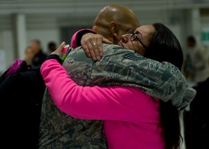 U.S. Air Force Tech. Sgt. Abraham Lailson, 1st Maintenance Group weapons standardization technician, is greeted by his wife Tech. Sgt. Berenice Lailson, Air Combat Command A4 Directorate of Maintenance and Logistics equipment manager, at Langley Air Force Base, Va., April 19, 2014. The 94th Fighter Squadron returned from a nearly four-month deployment to Kadena Air Base, Japan. (U.S. Air Force photo by Staff Sgt. John D. Strong II/Released)