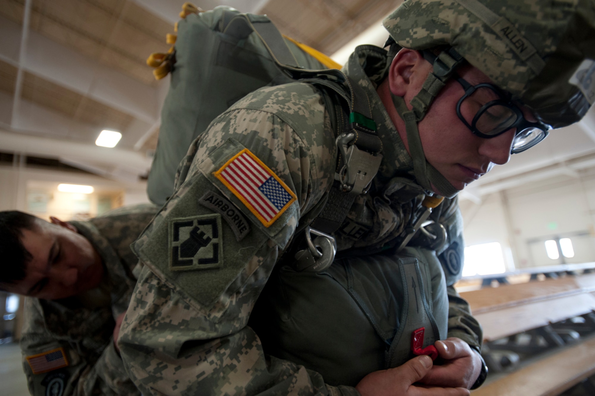 Army 1st Lt. Robert Tester, 84th Engineer Support Company (Airborne), 6th Engineer Battalion (Combat)(Airborne) executive officer and jumpmaster performs a jumpmaster personnel inspection on Spc. Randall Allen, 23rd Engineer Company (Sapper), 6th Engineers, in the Joint Mobility Center at Joint Base Elmendorf-Richardson, Alaska, April 15, 2014. The role of a jumpmaster includes ensuring the jump is safe and parachutes are prepared properly. (U.S. Air Force photo/Staff Sgt. Robert Barnett)