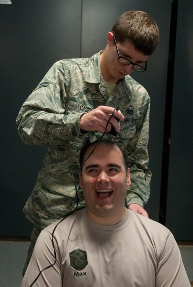Airman 1st Class Christian Case, 90th Civil Engineer Squadron, shaves the head of Master Sgt. Royal Maxey, 90th CES first sergeant, April 17 during their monthly Prime Base Engineers Emergency Force Day. Prime BEEF Day is held every third Thursday in the Emergency Management Building. The 90th CES celebrates 180 days without DUIs. Maxey plans to hold a pugil stick tournament when the squadron’s next DUI-prevention milestone is reached.
