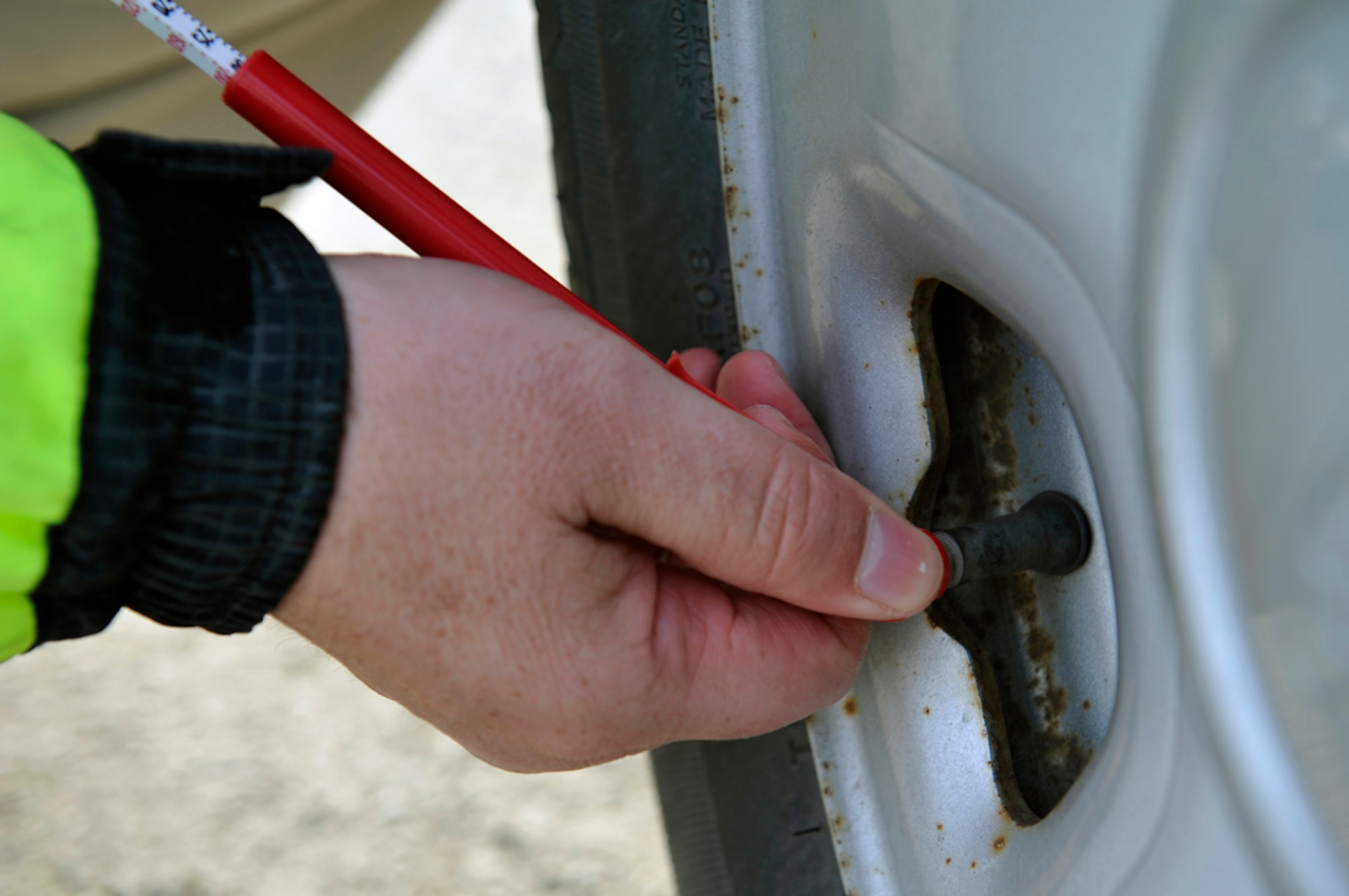 Michael Lundvall, 673d Air Base Wing Safety ground safety lead and vehicle control officer, checks the tire pressure on a government vehicle on Joint Base Elmendorf-Richardson, Alaska, April 16, 2014. VCOs help ensure effective utilization, training, operator care and maintenance of their unit’s vehicle assets. (U.S. Air Force photo/Airman 1st Class Tammie Ramsouer)