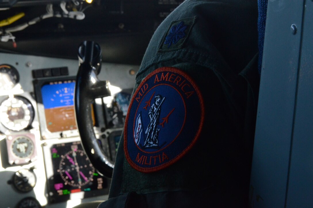 A pilot with the 108th Air Refueling Squadron wears a shoulder patch showing the heritage of the unit during an aerial refueling mission, April 16, 2014. The 108 ARS is an Illinois Air National Guard unit, assigned to the 126th Air Reufeling Wing, that spent over 70 years in Chicago before being relocated to Scott Air Force Base, Ill. The patch hightlights the National Guard heritiage by displaying the Mintueman statue and its Chicago era by showing the city of Chicago flag. The 126 ARW, an Illinois Air National Guard unit stationed at Scott Air Force Base, supports USSTRATCOM's global strike and strategic deterrence missions through aerial refueling with the KC-135R Stratotanker to deter regional and strategic threats from adversaries with ground warfare capabilities. (Air National Guard photo by Senior Airman Elise Stout)