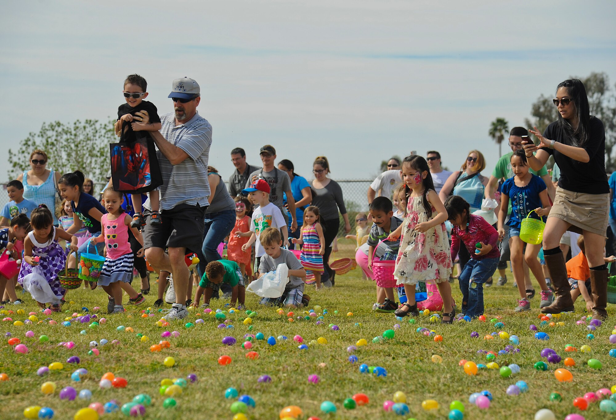 Luke families run onto the softball field to gather eggs during the annual event. (U.S. Air Force photo/Staff Sgt. Darlene Seltmann)