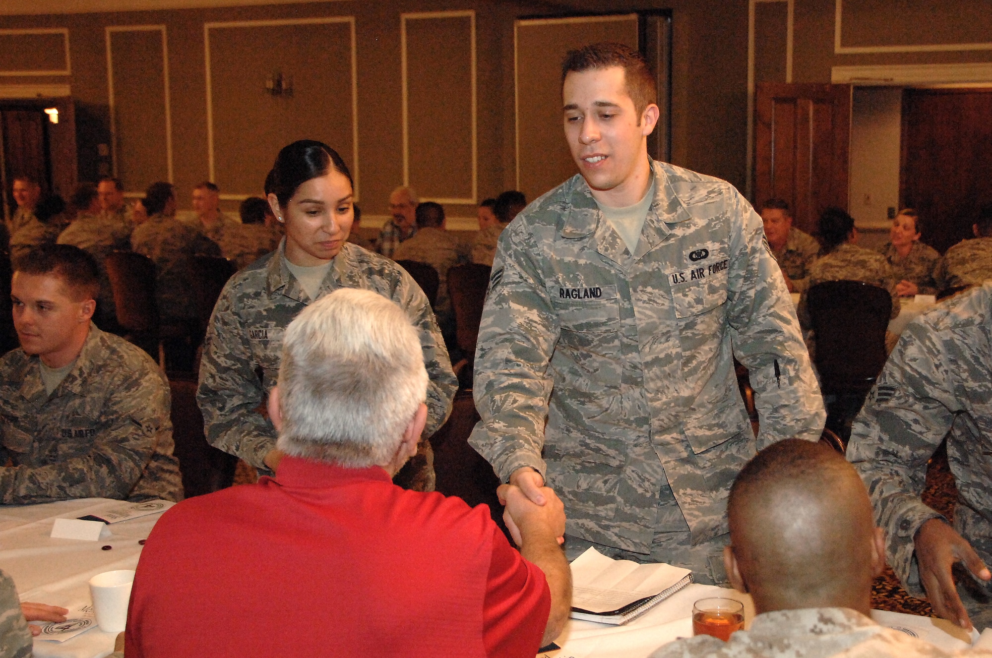 Senior Airman Anthony Ragland finishes a mentoring session with Mr. Sam Hyman, a retired chief master sergeant and current federal civilian employee. Ragland was one of 60 Airmen who met with senior leadership as part of a speed-mentoring session put on by the Offutt Elite Four professional organization April 15, 2014 at Offutt Air Force Base, Neb. (U.S. Air Force Photo/Delanie Stafford)