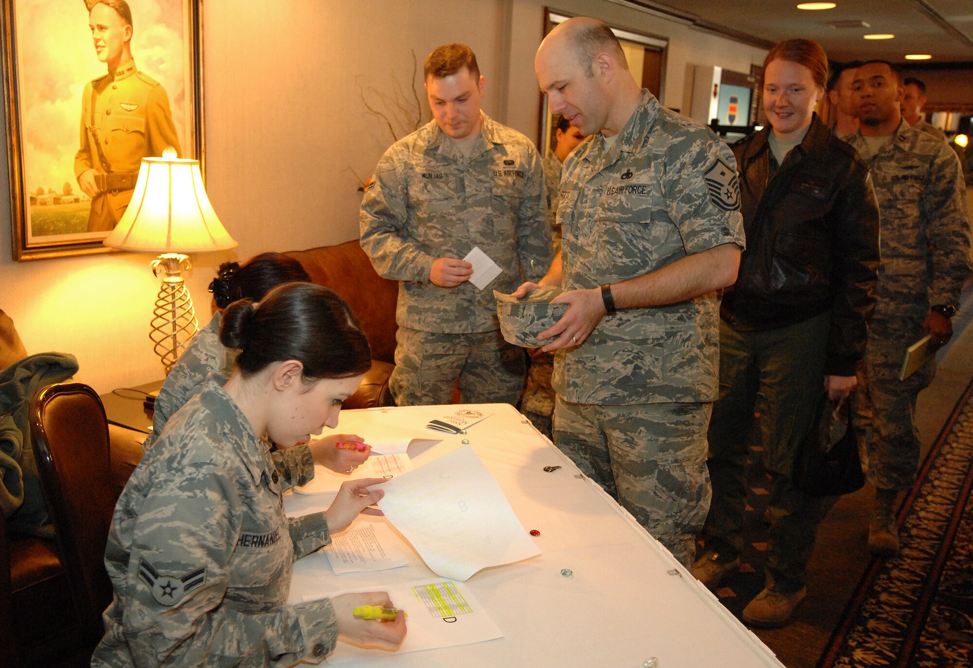 Airman 1st Class Evelyn Hernandez (left) checks in mentors as part of a speed-mentoring event held April 15, 2014 at Offutt Air Force Base, Neb. Hernandez is the secretary of the Offutt Elite Four who coordinated the event. She also participated in the event as a mentored Airman. (U.S. Air Force Photo/Delanie Stafford)