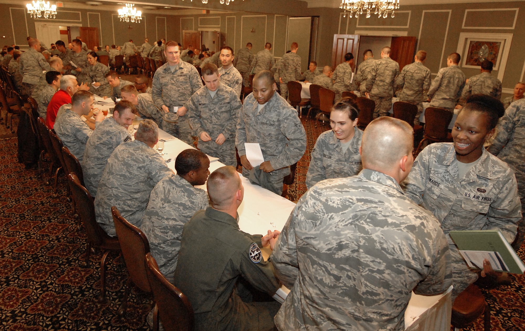 Airmen from various Offutt units move to the next mentor in-line as part of a speed-mentoring session held April 15, 2014 at Offutt Air Force Base, Neb. The event was coordinated by the Offutt Elite Four professional organization, and provided an opportunity for Airmen to meet with multiple senior enlisted members and officers to discuss career development. (U.S. Air Force Photo/Delanie Stafford)