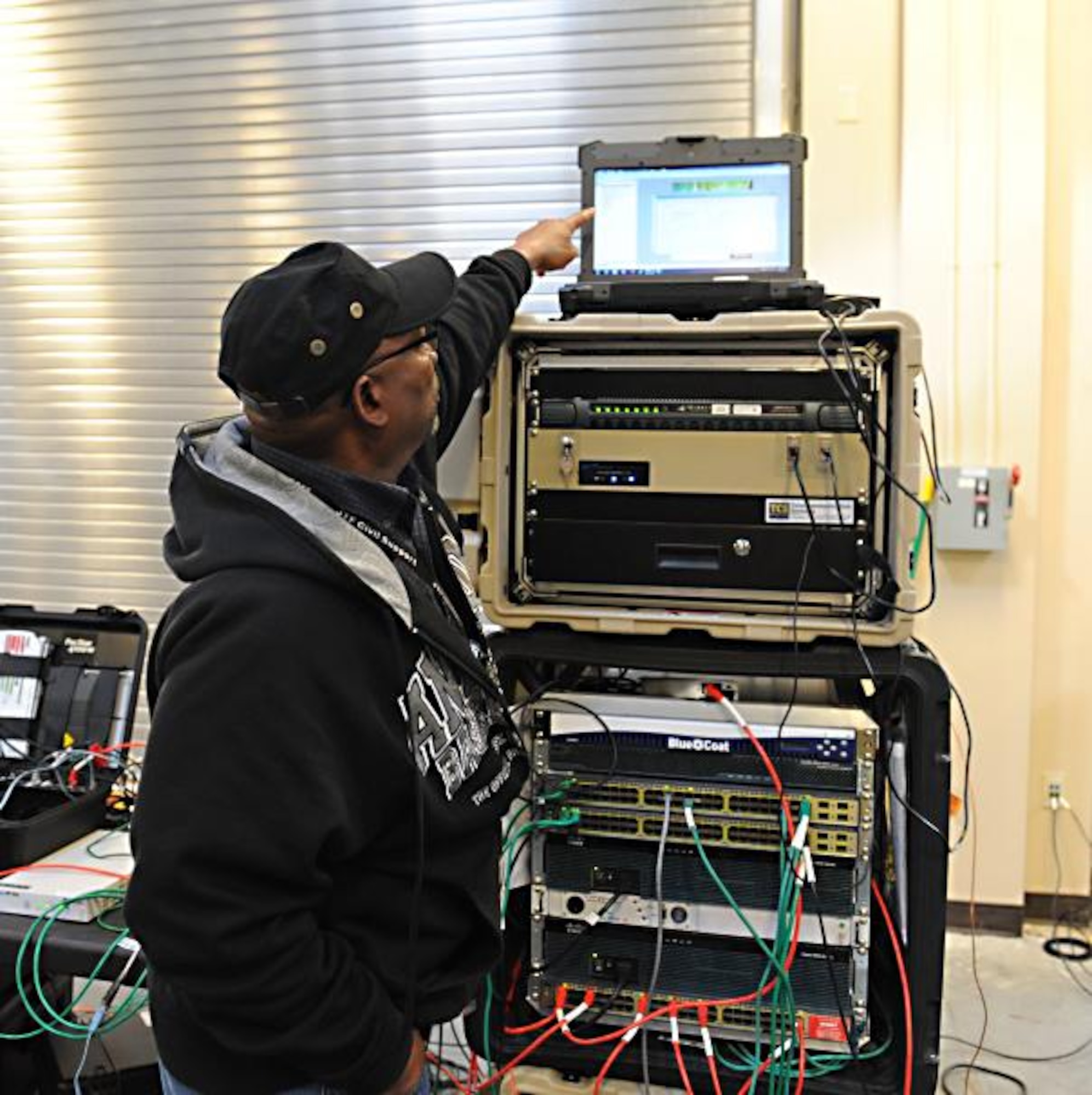 Curtis Wright, Joint Task Force Civil Support telecommunications engineer, verifies the connection of satellite communication equipment during an internal communication exercise at Fort Eustis, Va., April 16, 2014. Members of the communications directorate conducted an internal exercise to validate their communications equipment in preparation for the upcoming Sudden Response command post exercise in May and to train new personnel. JTF-CS anticipates, plans and prepares for chemical, biological, radiological and nuclear defense support to civil authorities. (Department of Defense photo by U.S. Navy Petty Officer 1st Class Brian Dietrick/Released)