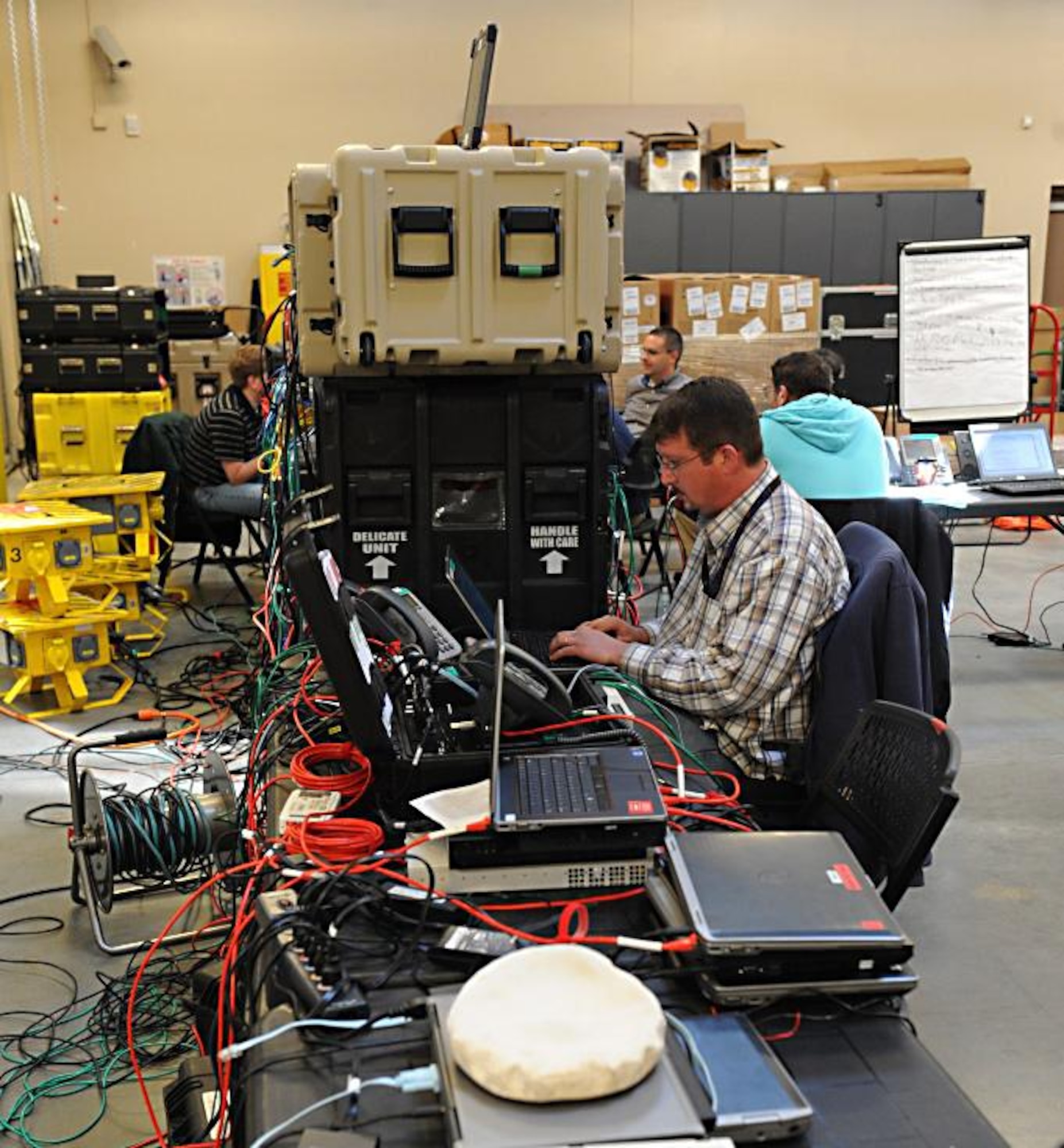 Richard Tyson, Joint Task Force Civil Support network engineer, sets up a deployed communications network during an internal communication exercise at Fort Eustis, Va., April 16, 2014. Members of the communications directorate conducted an internal exercise to validate their communications equipment in preparation for the upcoming Sudden Response command post exercise in May and to train new personnel. JTF-CS anticipates, plans and prepares for chemical, biological, radiological and nuclear defense support to civil authorities. (Department of Defense photo by U.S. Navy Petty Officer 1st Class Brian Dietrick/Released)