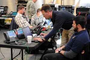 Rick George, Joint Task Force Civil Support communications control center chief, and Karl Ludwig, JTF-CS deployed communications technician, check the connection of their deployed communications gear during an internal communication exercise at Fort Eustis, Va., April 16, 2014. Members of the communications directorate conducted an internal exercise to validate their communications equipment in preparation for the upcoming Sudden Response command post exercise in May and to train new personnel. JTF-CS anticipates, plans and prepares for chemical, biological, radiological and nuclear defense support to civil authorities. (Department of Defense photo by U.S. Navy Petty Officer 1st Class Brian Dietrick/Released)