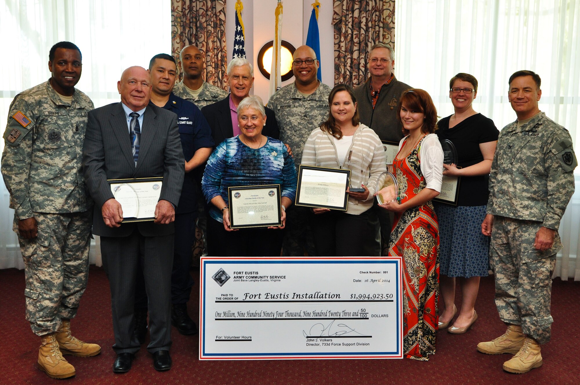 Winners from eight different volunteer of the year categories pose for a picture during an award ceremony at Fort Eustis, Va., April 16, 2014. The categories included youth, civilian, retiree, single Soldier, military, family, family member and overall volunteer of the year. (U.S. Army photo by Sgt. Stephanie Warner/Released) 