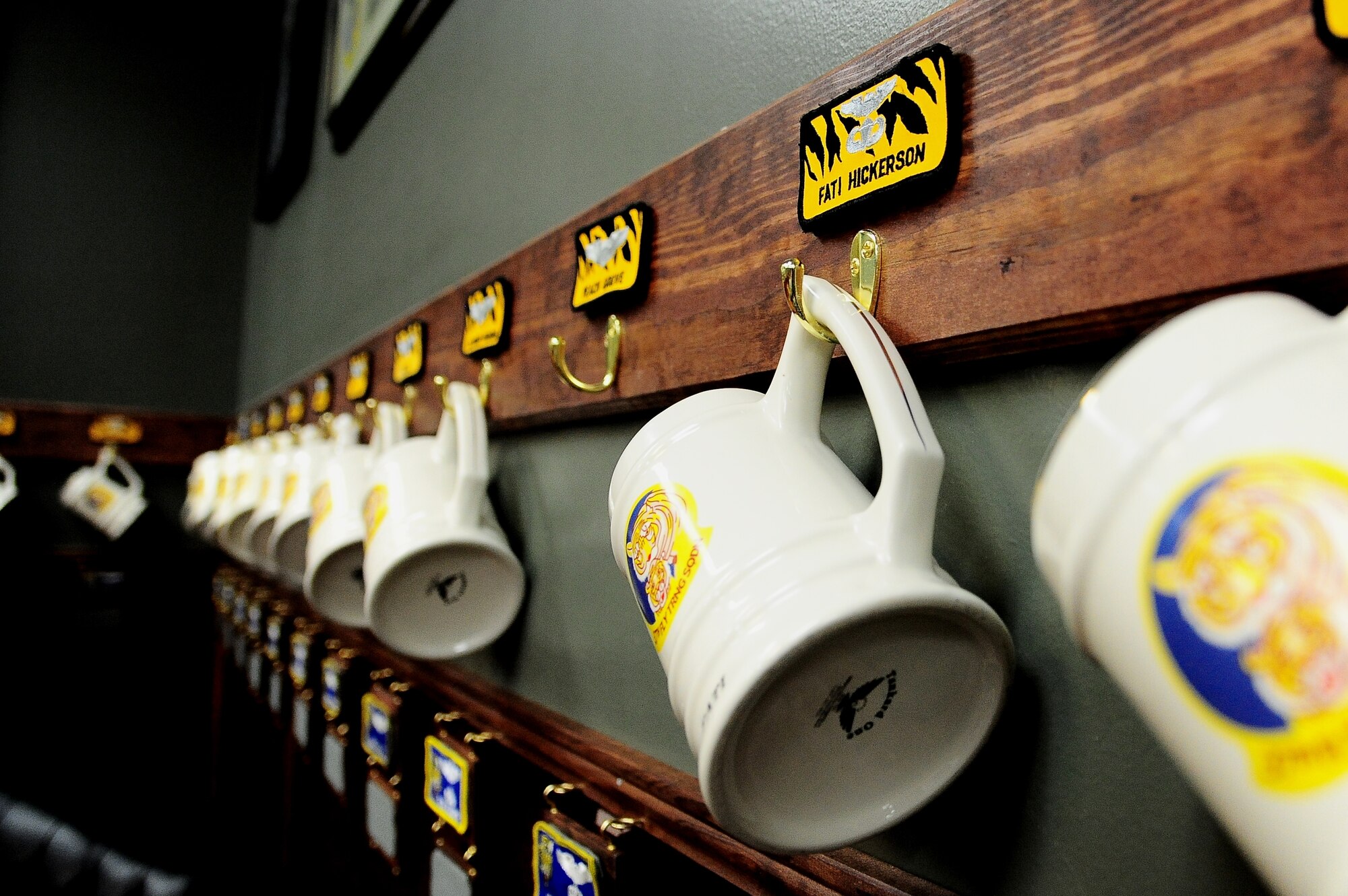 Mugs and nametags hang on the wall of the 37th Flying Training Wing’s heritage room at Columbus Air Force Base, Miss., April 16. After a member of the squadron leaves, their nametag is left on the wall underneath the mug. (U.S. Air Force photo by Senior Airman Kaleb Snay)