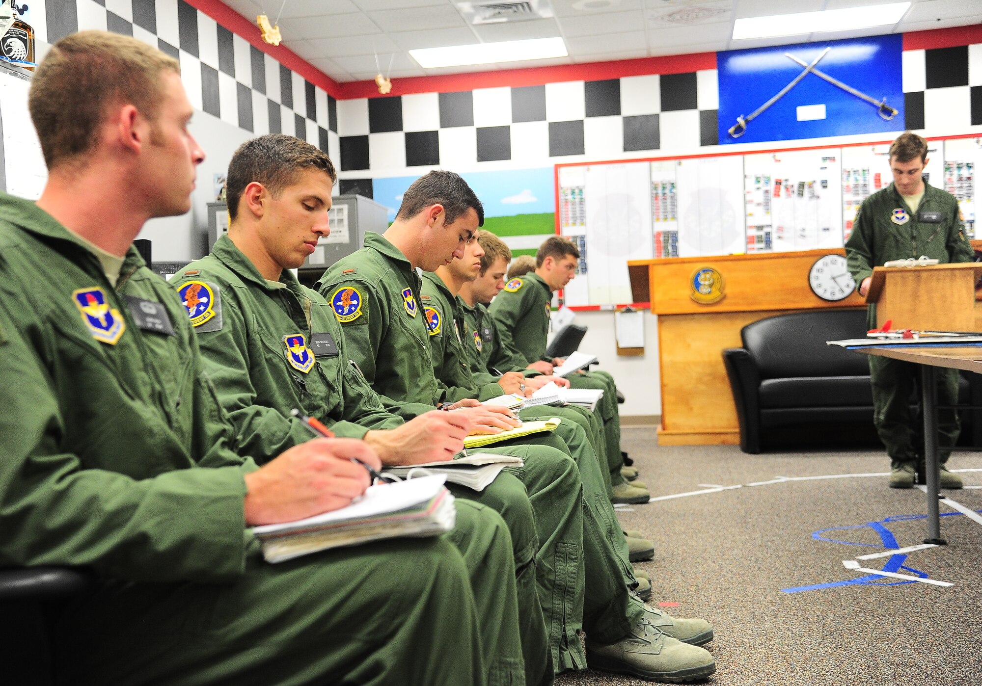 A Specialized Undergraduate Pilot Training class participates in an emergency procedure brief aka a stand-up brief at Columbus Air Force Base, Miss., April 16. Pilots are taken through four basic categories of aviation while in the 37 FTS before they can proceed in their training. They cover contact, final contact, instruments and formation. (U.S. Air Force photo by Senior Airman Kaleb Snay)