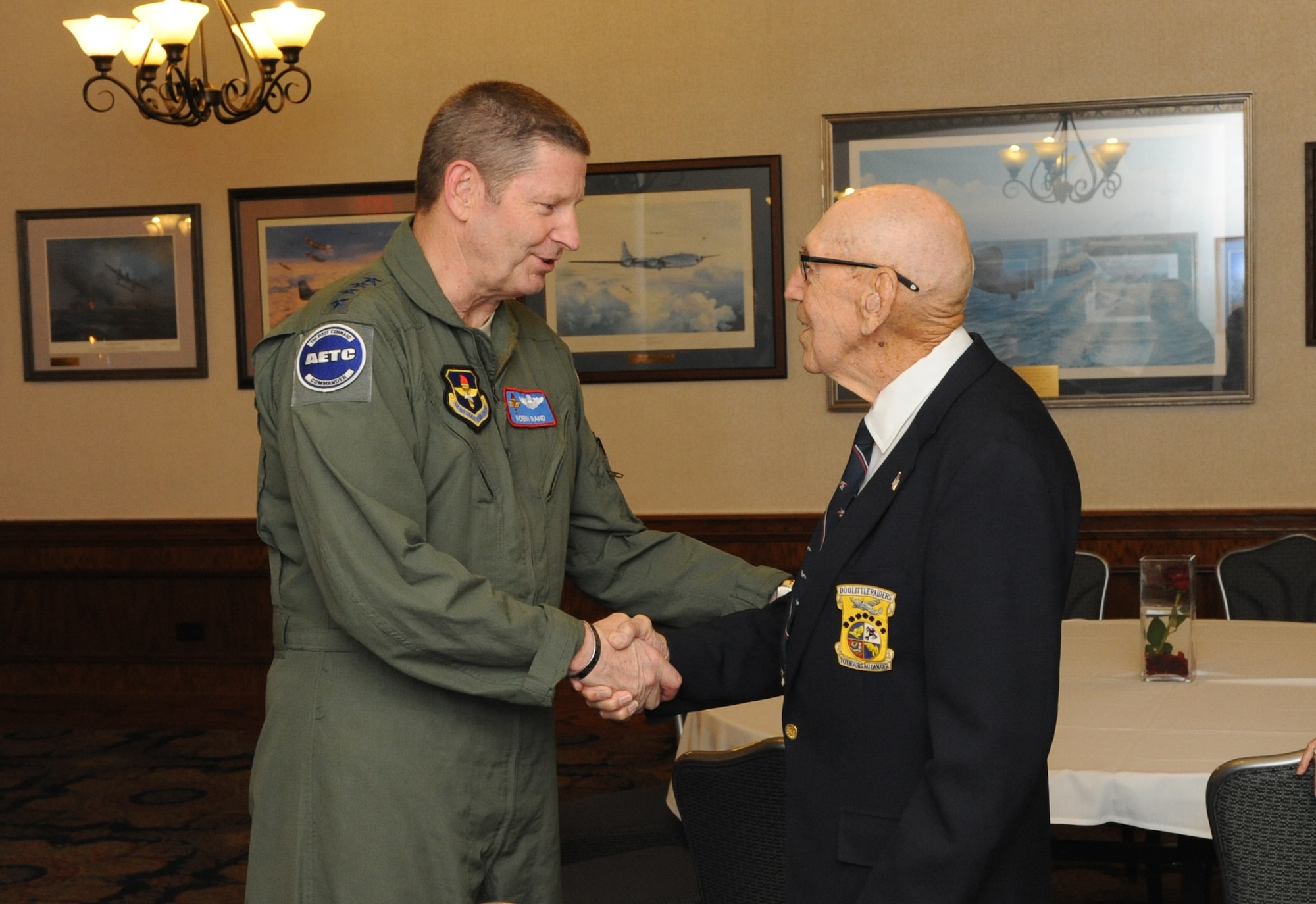 Gen. Robin Rand, Air Education and Training Command commander, shakes hands with retired Lt. Col. Richard Cole, co-pilot of Aircraft No. 1 of the Doolittle Toyko Raid. Cole was honored during the 72nd anniversary celebration of the Doolittle Tokyo Raid of April 18, 1942.  Cole is one of four remaining survivors of the mission. (U.S. Air Force photo by Melissa Peterson)