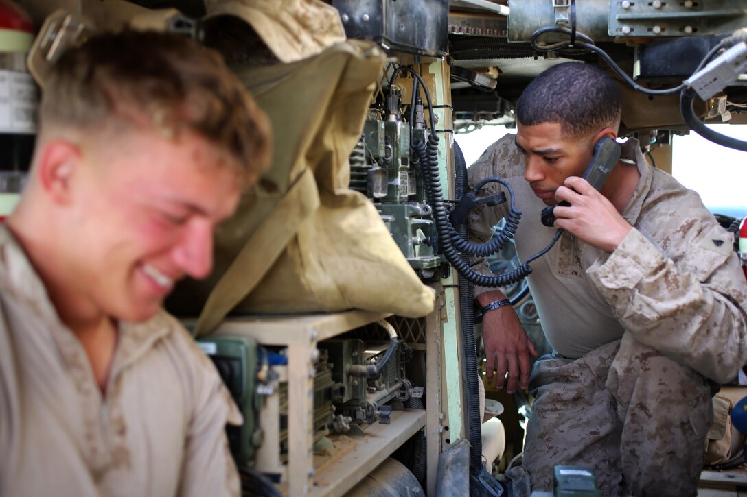 U.S. Marine Corps Cpl. Jerome Christian and U.S. Marine Corps Lance Cpl. Damian Monson prepare their vehicle for a patrol on Camp Dwyer in Helmand province, Afghanistan, April 11, 2014. Christian and Monson, mortormen, are assigned to 1st Battalion, 9th Marine Regiment.